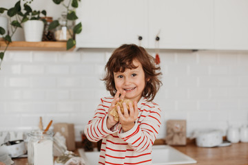 4 years cute girl making traditional Christmas cookies.