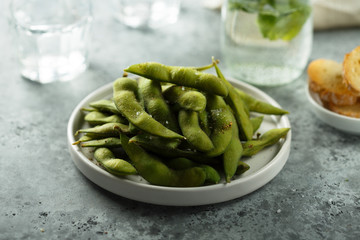 Edamame beans on a white plate