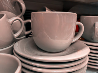 rosy ceramic cup on saucers close up