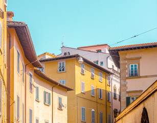 Fototapeta na wymiar Typical italian street view cityscape in a summer day under light blue sky