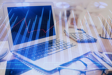 Double exposure of chart and financial info and work space with computer background. Concept of...