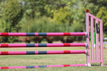 Image of show jumping poles on empty training field.