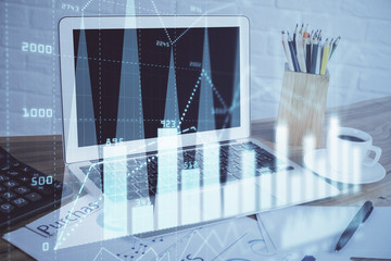 Forex graph hologram on table with computer background. Multi exposure. Concept of financial markets.