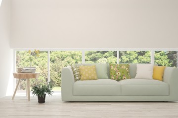 Stylish room in white color with sofa and summer landscape in window. Scandinavian interior design. 3D illustration