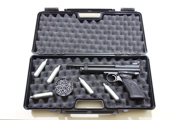 Air gun pistol in a plastic hard pistol case with round box of lead pellets and capsules of 12...