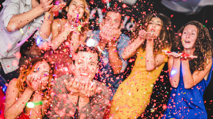 Young friends having party throwing confetti - Focus on close-up man hands