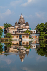 Shiva temple reflecting in a pond in Puthia village, Bangladesh