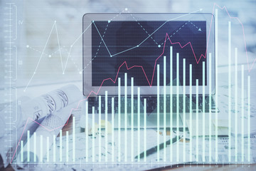 Financial graph colorful drawing and table with computer on background. Multi exposure. Concept of international markets.