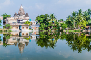 Fototapeta premium Shiva temple reflecting in a pond in Puthia village, Bangladesh