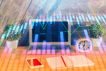 Multi exposure of graph and financial info and work space with computer background. Concept of international online trading.