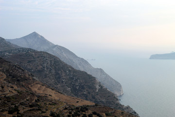 Sunset seen from the beautiful Greek island of Sikinos. View over the Aegean sea to the nearby island if Milos.