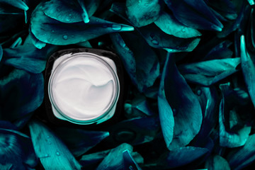 Luxury face cream moisturizer for facial skin on emerald flower background, floral essense, spa...