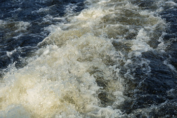 Obraz premium Cold foaming clear sea wave. Natural background of sea water with foam. Phantom classic blue color.