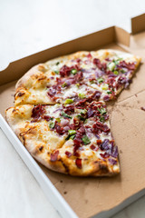 Flammkuchen Pizza Slices / Traditional Tarte Flambee with Creme Fraiche, Cream Cheese, Bacon and Red Onions in Box.