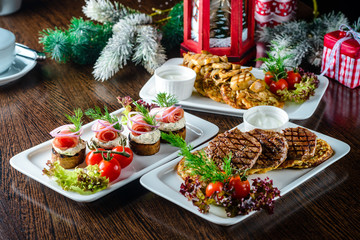 Christmas dinner, a table with festive dishes, food in plates on the table