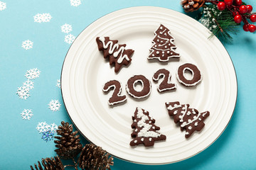 New Year and Christmas chocolate gingerbread cookies in silhouette of 2020. Homemade delicious bakery, sweet family time and traditions.