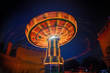 spinning carousel at amusement park.night time 