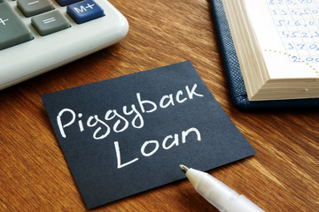 Piggyback loan handwritten sign on the black sheet.