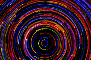Fototapeta na wymiar Rotating neon lights, spinning bright colorful laser lights background, modern nightlife and party concept, disco and dancing nightclubs pattern