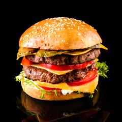 Homemade double cheese burger Black background
