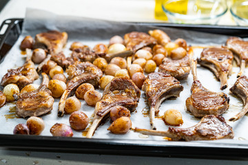 Baked Lamb Chops with Shallots on Baking Tray with Paper Sheet.
