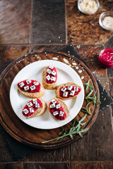 Canapes with horseradish and feta cheese sprinkled with sesame seeds. Appetizer for strong alcohol