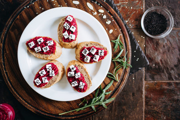 Canapes with horseradish and feta cheese sprinkled with sesame seeds. Appetizer for strong alcohol