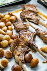 Baked Lamb Chops with Shallots on Baking Tray with Paper Sheet.