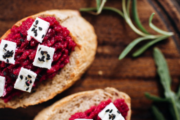 Canapes with horseradish and feta cheese sprinkled with sesame seeds. Appetizer for strong alcohol