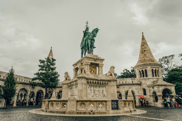 Fototapeta na wymiar Monument to King Matthias against the background of the towers of the Fisherman's Bastion in Budapest