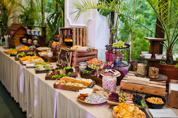 Dessert table of delicious snacks on wedding reception.