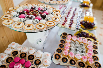 Dessert table of delicious sweets on wedding reception.