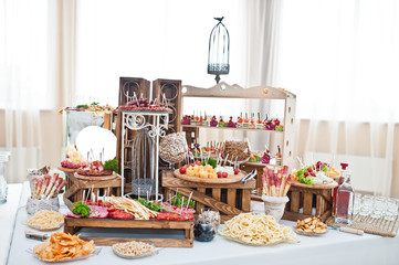 Dessert table of delicious snacks on wedding reception.