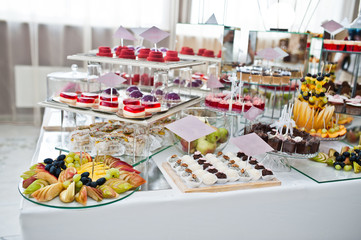Dessert table of delicious sweets on wedding reception.