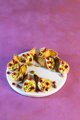 Qatayef is an Arabic dessert usually served during the month of Ramadan, pancakes filled with cream or cottage cheese and pistachios.