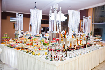 Dessert table of delicious sweets on wedding reception.