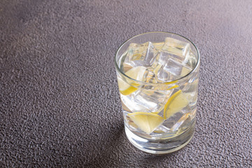 A glass of ginger water on grey table. Detox drink.