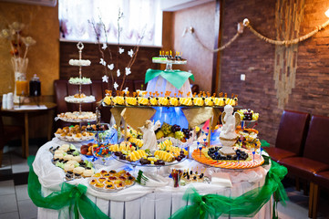 Dessert table of delicious sweets on wedding reception.