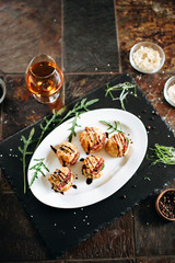 Cheese donuts with salami and cucumbers under balsamic sauce. Catering