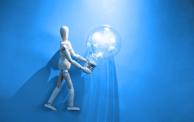 Wooden puppet with light bulb