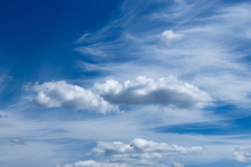 plumose clouds of the top tier in blue space of the sky