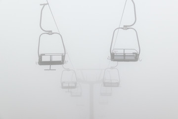 Empty ski chair lift in deep fog in Glen Coe, Scotland.