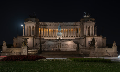 The great national monument The Victor Emmanuel II in white marble called "Altare della Patria" at night in the square (Piazza) Venezia in Rome, Italy