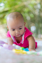 Fototapeta na wymiar Cute little Asian baby sitting and play with happiness select focus shallow depth of field