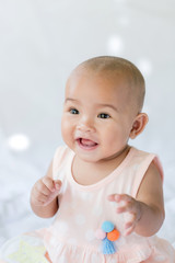 Cute little Asian baby sitting and play with happiness select focus shallow depth of field