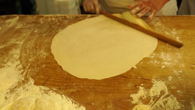 Turkish woman preparing dough  to make gozleme, 