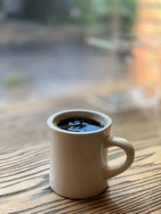cup of coffee on wooden table