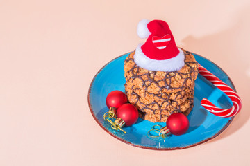 Christmas holiday cookies homemade sweet dessert on a blue plate and attributes symbols of the New Year top view on a peach color background with copy space