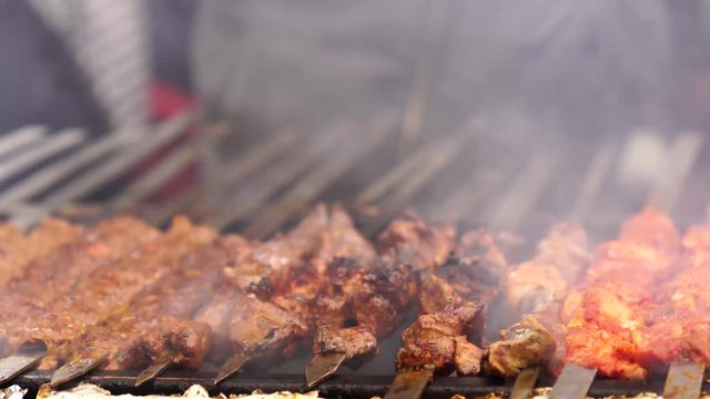 Turkish Adana kebab, ciger kebab on fire with smoke
