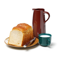 Milk and bread on white background